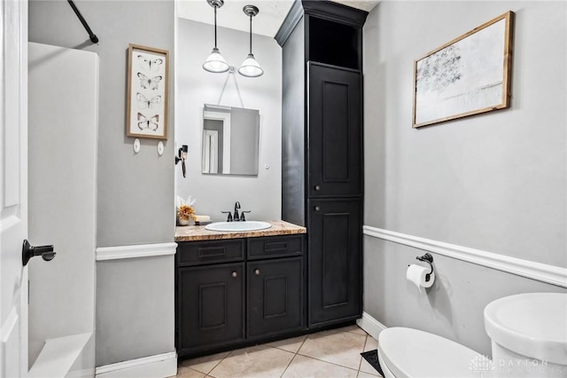 full bathroom with toilet, tile patterned flooring, a shower, baseboards, and vanity