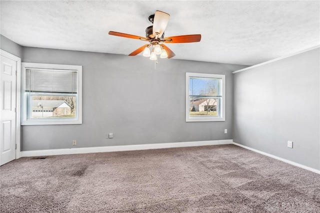 unfurnished room featuring carpet flooring, a textured ceiling, and baseboards