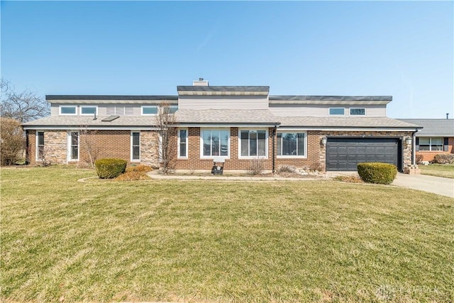 view of front of house with driveway, a shingled roof, a front lawn, a garage, and brick siding