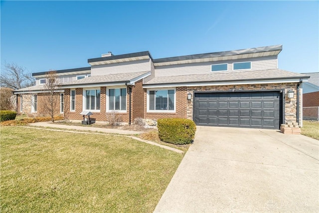 traditional-style house featuring brick siding, roof with shingles, concrete driveway, and a front lawn