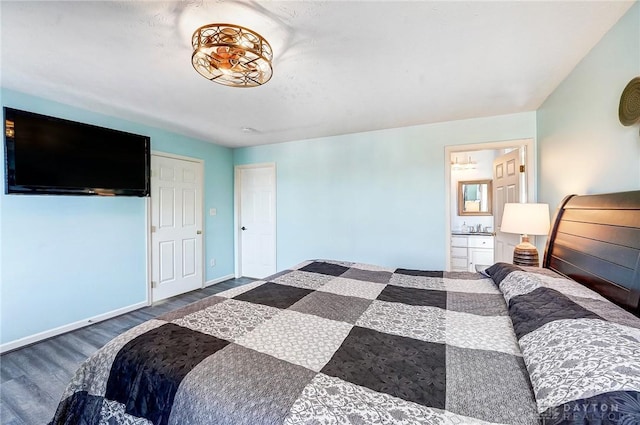 bedroom with baseboards and wood finished floors