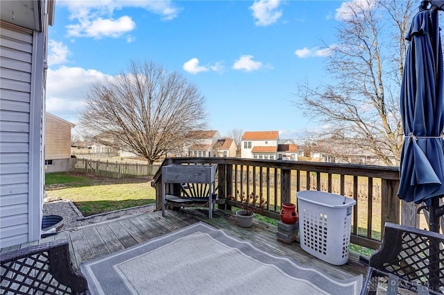 deck featuring a residential view, a yard, and fence