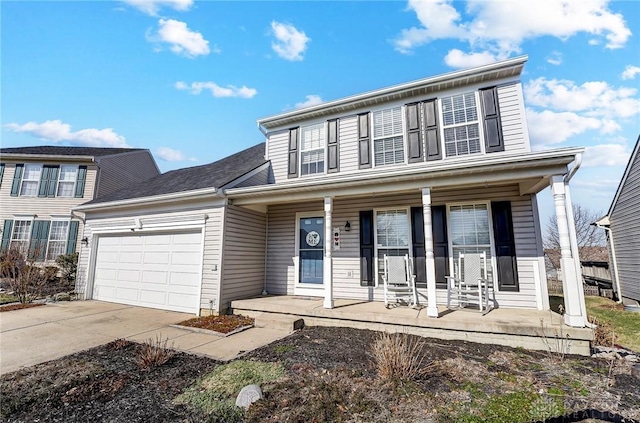 view of front of home featuring covered porch, an attached garage, and driveway