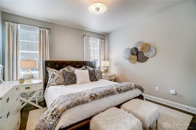 bedroom featuring wood finished floors and baseboards