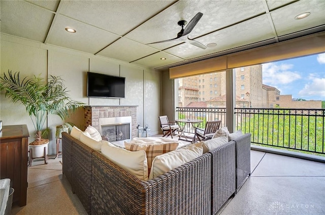 living room with a brick fireplace, recessed lighting, a ceiling fan, and a wealth of natural light