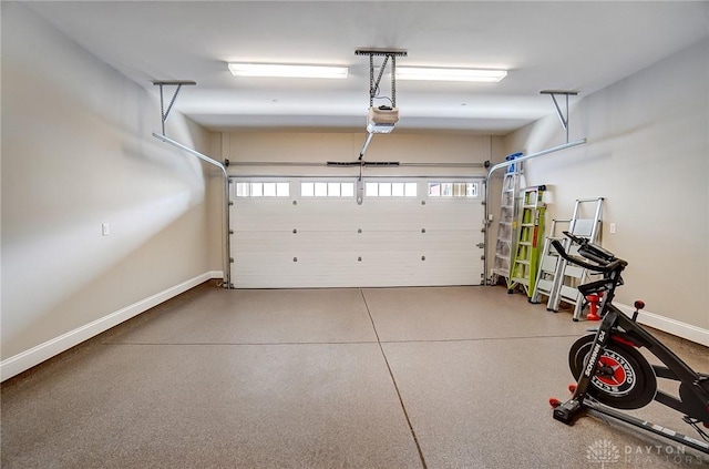 garage with a garage door opener and baseboards