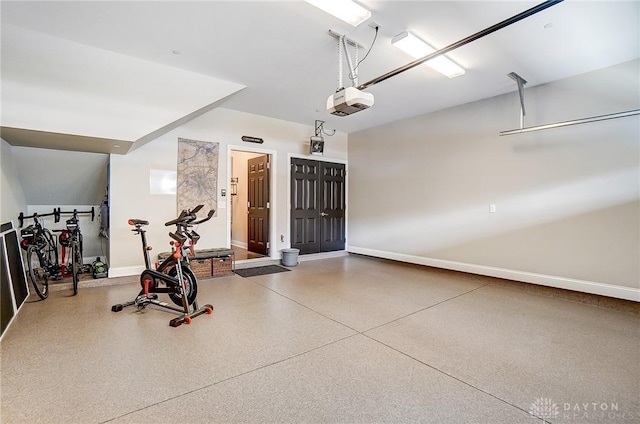 garage featuring a garage door opener and baseboards