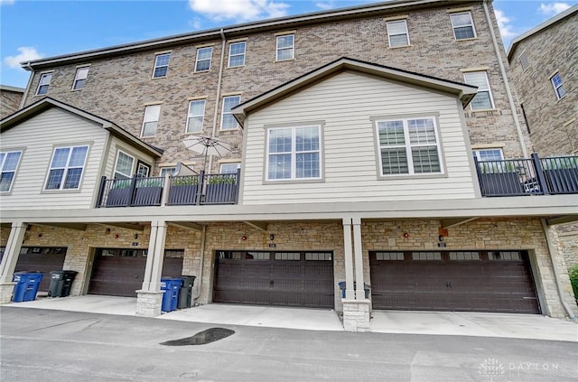 back of property with a balcony and a garage