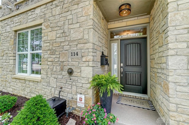 view of exterior entry featuring stone siding