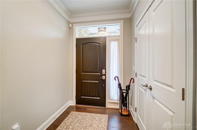 entrance foyer with dark wood finished floors, crown molding, and baseboards