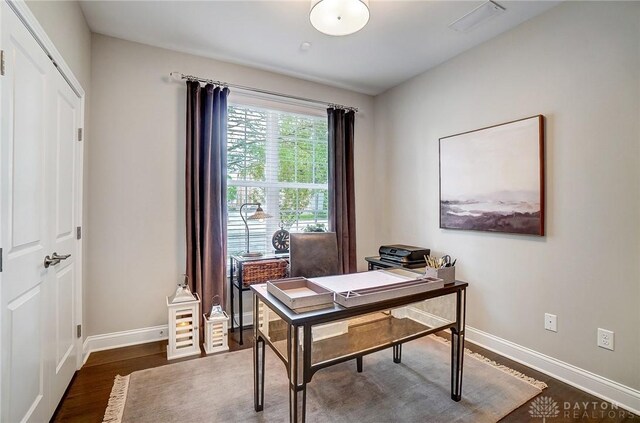 office area featuring visible vents, baseboards, and dark wood-style flooring