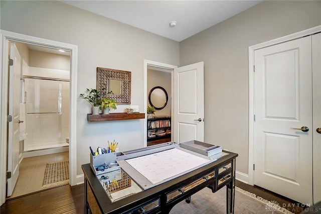 office area with baseboards and dark wood-style flooring