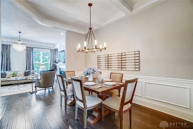 dining space featuring dark wood-type flooring, a notable chandelier, and beam ceiling