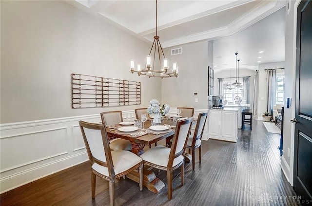 dining area featuring visible vents, a wainscoted wall, a notable chandelier, dark wood-style floors, and a decorative wall