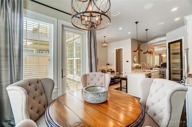 dining room featuring a notable chandelier, recessed lighting, visible vents, and a wealth of natural light