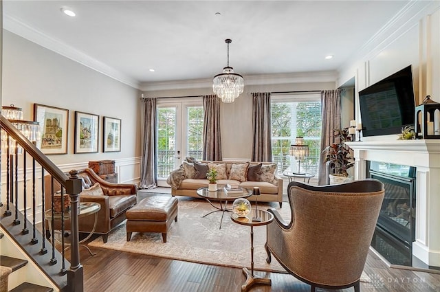 living room featuring a wealth of natural light, stairway, and wood finished floors