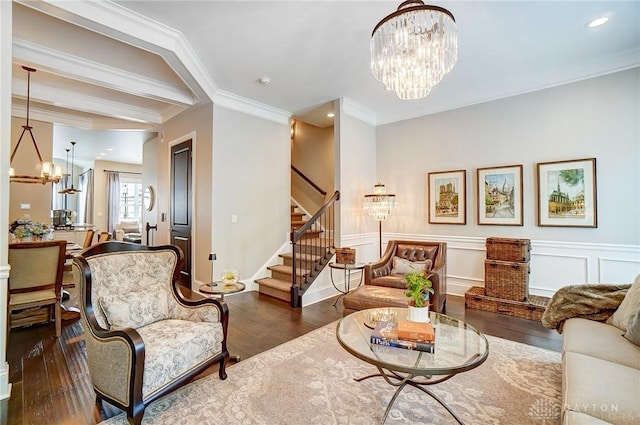 living area with a notable chandelier, ornamental molding, hardwood / wood-style flooring, recessed lighting, and stairway