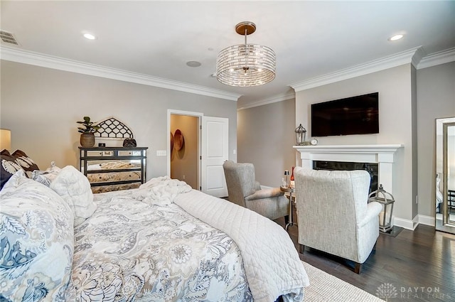 bedroom with a fireplace, dark wood-style floors, baseboards, and ornamental molding