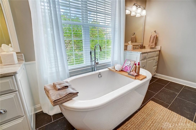 bathroom with a freestanding bath and vanity