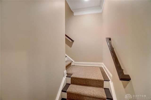 stairs featuring crown molding and baseboards