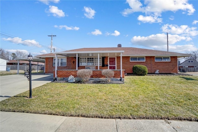 single story home featuring a porch, a carport, brick siding, and driveway