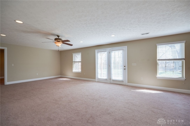 carpeted spare room with visible vents, baseboards, ceiling fan, recessed lighting, and a textured ceiling