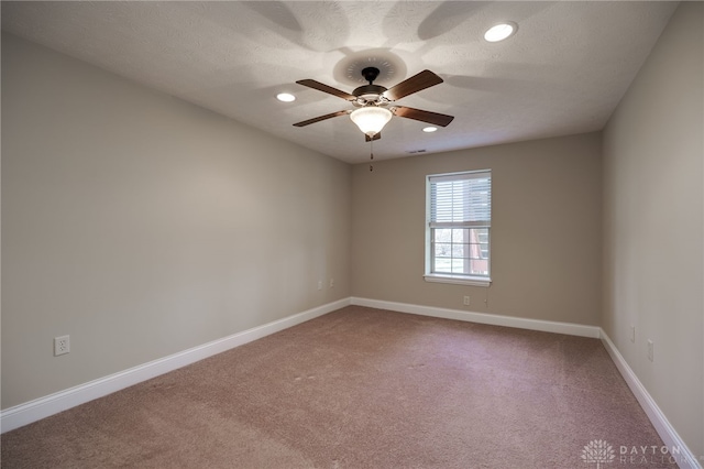 spare room featuring recessed lighting, a ceiling fan, carpet, and baseboards