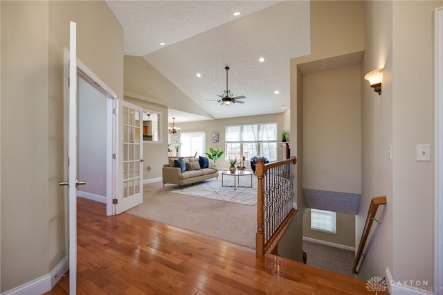 living area with recessed lighting, visible vents, baseboards, and hardwood / wood-style flooring