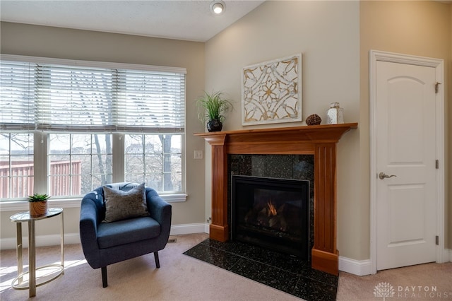 sitting room featuring baseboards, carpet, and a fireplace