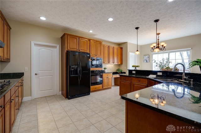 kitchen featuring recessed lighting, brown cabinets, black appliances, and a sink