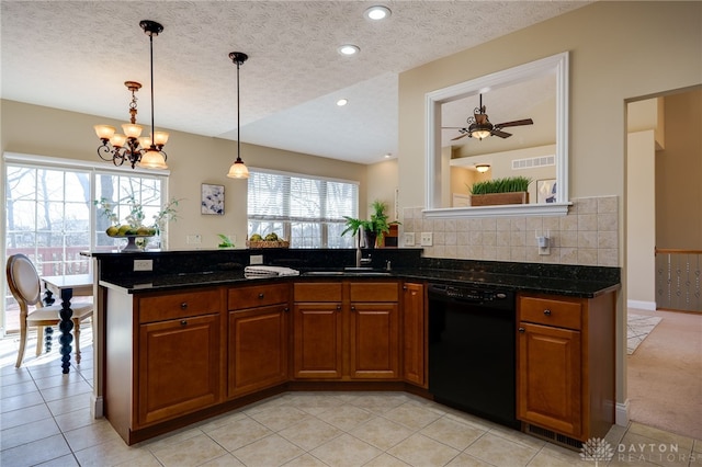 kitchen featuring visible vents, brown cabinets, a sink, black dishwasher, and a textured ceiling