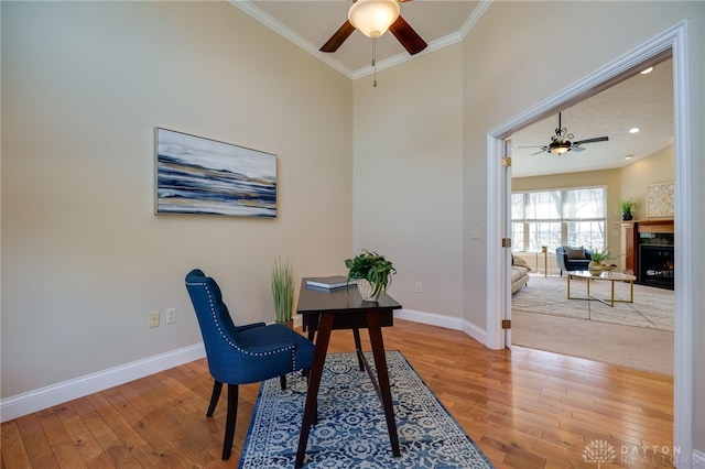 office featuring light wood finished floors, baseboards, and ornamental molding