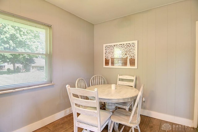 dining space featuring baseboards and wood finished floors