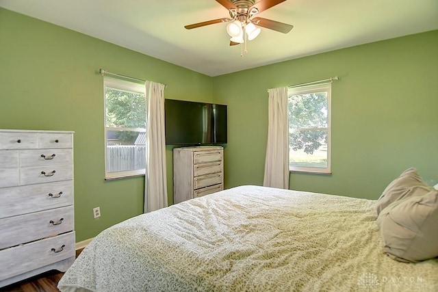 bedroom with ceiling fan and dark wood-style flooring