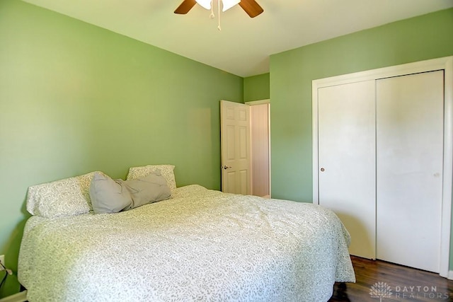 bedroom with a closet, ceiling fan, and dark wood-style flooring