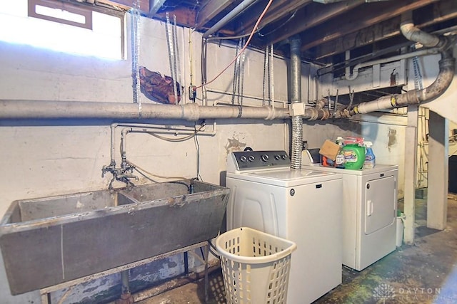 laundry room featuring laundry area, independent washer and dryer, and a sink