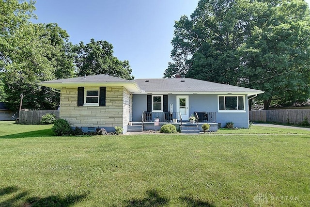 view of front of home featuring a front yard, fence, stone siding, and crawl space