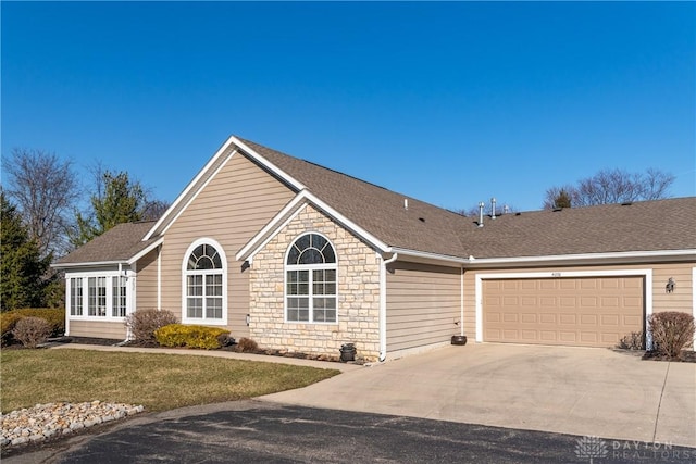 ranch-style house with stone siding, roof with shingles, and driveway