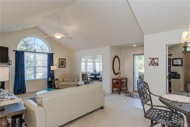 living room with light tile patterned floors, baseboards, lofted ceiling, and a ceiling fan