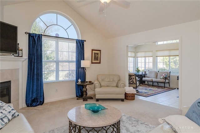 living room with carpet flooring, a wealth of natural light, and a tile fireplace