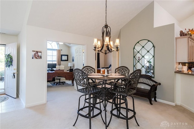 dining room with baseboards, light colored carpet, and vaulted ceiling