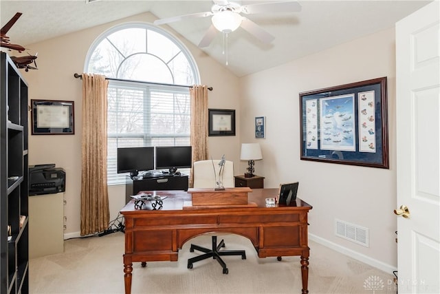 office featuring baseboards, visible vents, lofted ceiling, ceiling fan, and light colored carpet