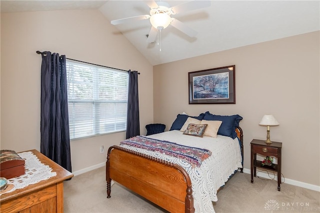 bedroom with lofted ceiling, a ceiling fan, baseboards, and light carpet