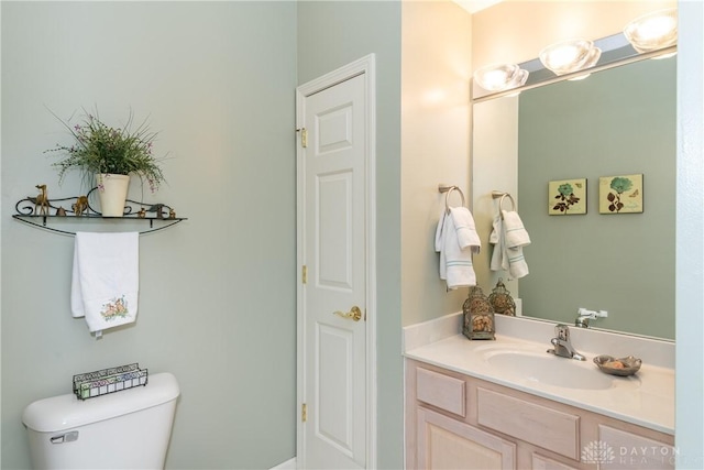 bathroom featuring toilet and vanity