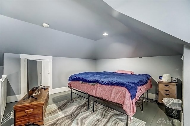 bedroom featuring baseboards and vaulted ceiling