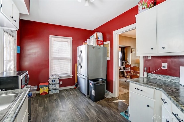 kitchen featuring white cabinets, dark wood-style floors, baseboards, and stainless steel appliances