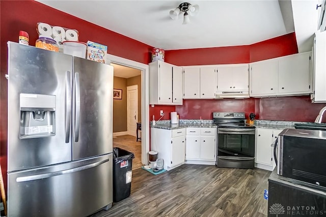 kitchen featuring dark wood-style floors, a sink, stainless steel appliances, white cabinets, and under cabinet range hood