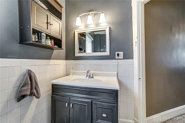 bathroom featuring vanity, tile walls, and wainscoting