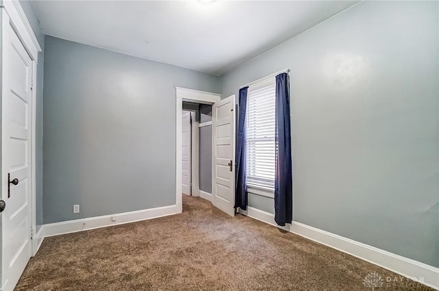 unfurnished bedroom with baseboards and carpet floors