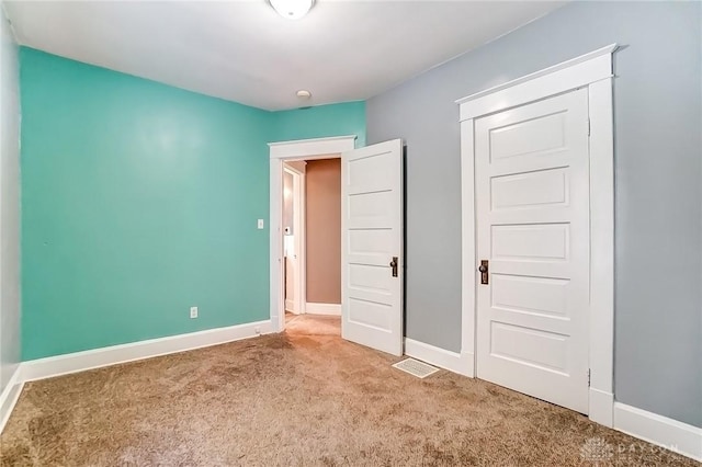 unfurnished bedroom with carpet and baseboards